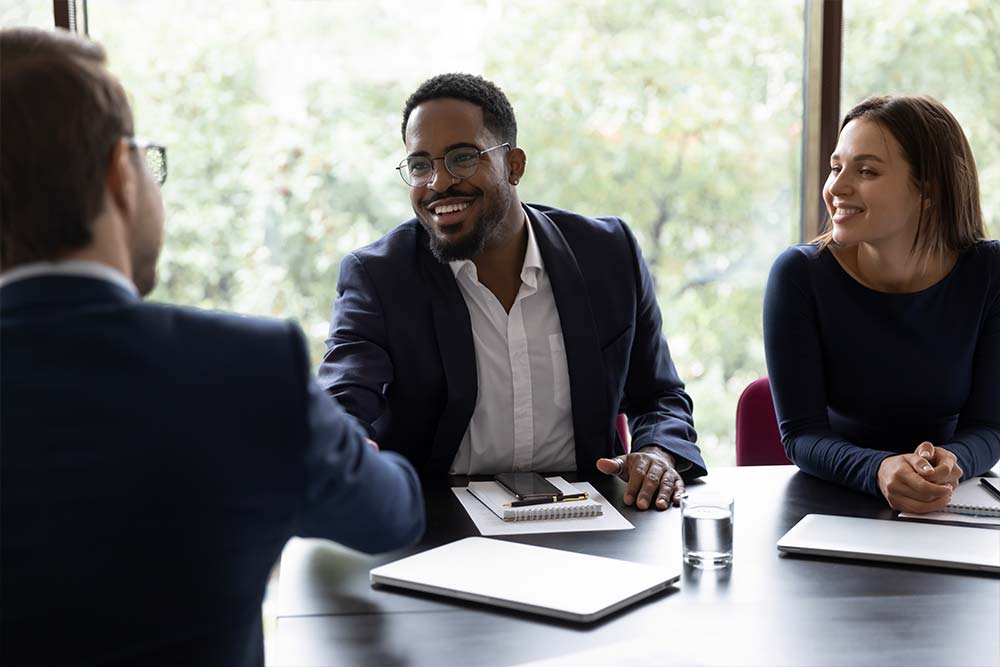 confident-executive-manager-welcoming-client-in-office